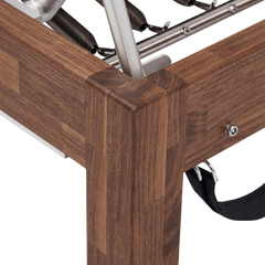 Solid Walnut Reformer, premium boutique pilates studio equipment by Consta Pilates Equipment.